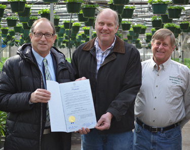 Photo of Secretary Fisher and Bob and Bill Eelman from Alexander Hay Greenhouses
