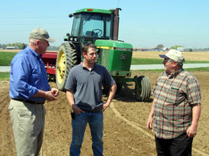Photo of Secretary Kuperus with Michael Brooks and his father Bill at their farm in Elmer