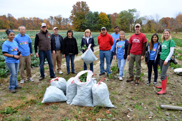 Photo of Secretary Fisher, Assemblywoman Nancy Pinkin and volunteers at gleaning