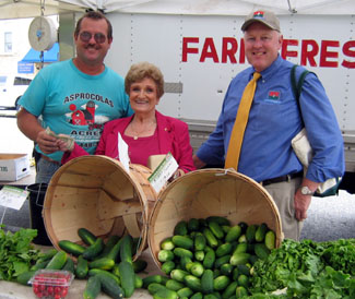 Photo of farmer George Asprocolas, Mayor Rose Heck and Secretary Kuperus at the Hasbrouck Heights farmers market