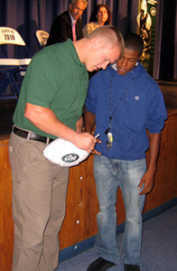 Photo of the Jets Matthew Mulligan signing an autograph during the program