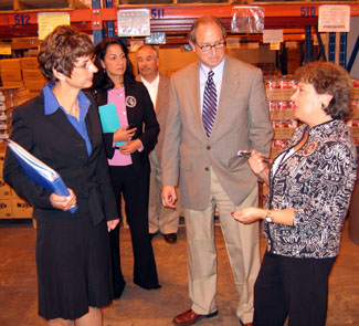 Photo of Commissioners Grifa and Velez and Secretary Fisher on a tour of the Mercer Street Friends food bank