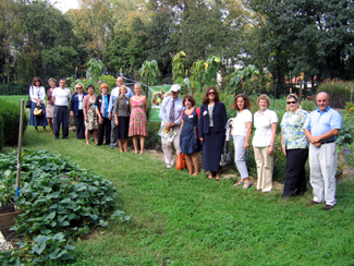 Photo of group of federal, state and school officials at the Riverside School garden
