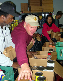 SECRETARY ASSEMBLES AND DISTRIBUTES THANKSGIVING FOOD BASKETS