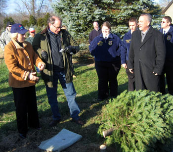 Photo of Lt. Governor Guadagno and Secretary Fisher chopping down a tree