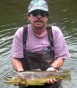 Brown trout held by biologist Bob Papson