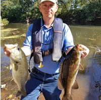 Biologist with Largemouth and Smallmouth Bass