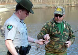 Officer field checks an angler