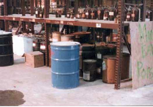 Photo 2 - A sample view of the types of chemical containers, as segregated by compatible type, during the 1985 emergency clean up. 