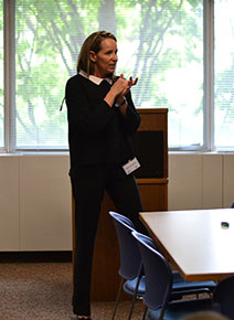 Junior Achievement of New Jersey President Catherine Milone speaks to children of Department staff about the importance of saving money at Take Your Children to Work Day.