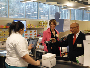 NJ State Board of Education President Arcelio Aponte pays for his purchases in the UCVTS real-life supermarket classroom. The market is staffed by special education students who are training for the workplace.