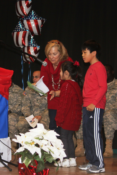 Gregory School Principal Michele Thompson with students reading letters to the U.S.Military