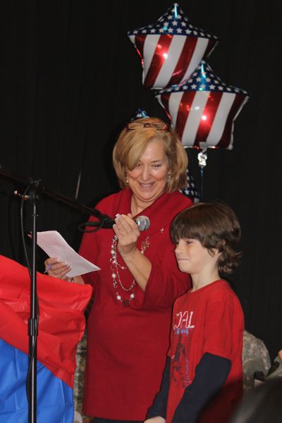 Gregory School student reads his letter to the U.S. Military, assisted by Principal Michele Thompson