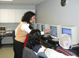 DHS Commissioner Jennifer Velez shows Trenton Area Soup Kitchen (TASK) patrons the state’s social services website, www.njhelps.org, to promote the availability of DHS and other state safety net programs, including online applications for Food Stamps