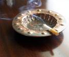cigarette in ashtray with smoke