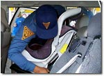 New Jersey State Trooper installing a child safety seat