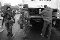 Co C 1-114th troops inspecting Truck at Path Station