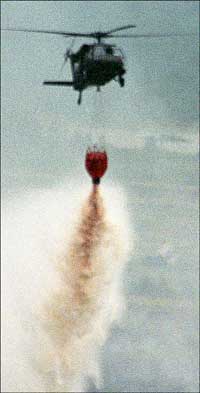 Blackhowk drop water on fire