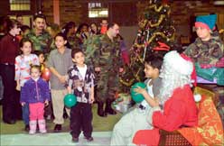 Children prepare to sit on santas lap
