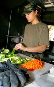 Spc. Maria Gibson chops veggies