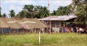 Displaced Panamanians at Boco de Cupe lin up for emergency relief supplies flown in by the 150th GSAB.