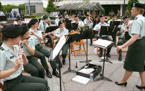 Chief Warrant Officeer 2 Dorinda Roth leads the 63rd Army Band on the rotunds outside the Statehouse.