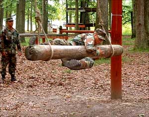 Cavalrymen from the 5th Squadron, 117th Cavalry watch as a  fellow Guardsman maneauvers through the confidence course at  Fort Dix during the Spur Ride held July 16-17.