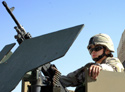 Spc. Dalila Navarro stands watch in the turret in front of the provisional governor's headquarters building. (Click to enlarge)