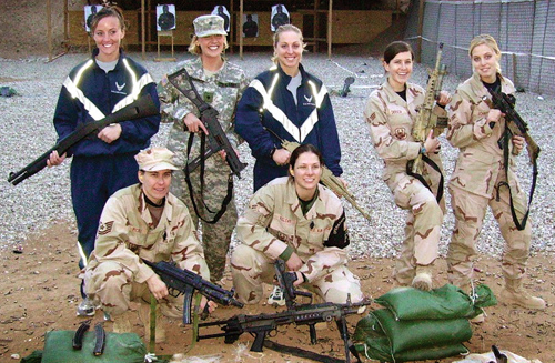 Staff Sergeants' Bridget Fitzsimmons and Jennifer Long (both
in PT gear) pose after target practice on the firing range.