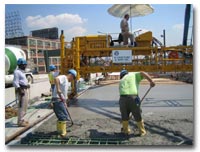 The concrete deck pour on the 14th Street Viaduct involves the process of screeding photo.