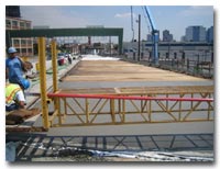 Crews work on the closure pours at deck joints and final grading of the concrete deck photo.
