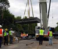 NJDOT personnel and ironworkers prepare to install a temporary bridge over Friendship Creek on Route 70 Southampton Township in Burlington County,