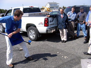 Photo of Joe Myers demonstrating how a clam rake is used for food retailers