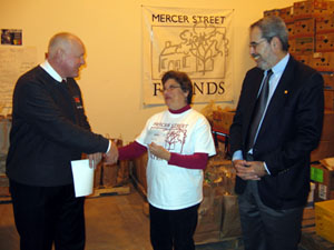 Photo of Secretary Kuperus giving Mercer Street Friends a grant check