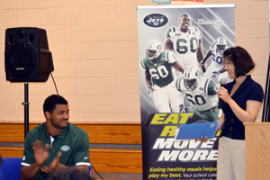 Photo of Jets lineback Aaron Maybin and NJDA's Arleen Ramos-Szatmary