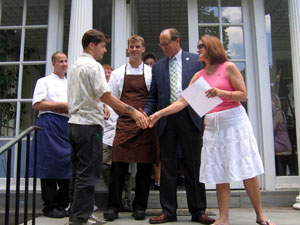 Photo of Scott Anderson being congratulated by Secretary Fisher and First Lady Mary Pat Christie