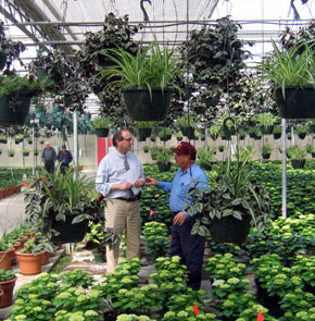 Photo of Secretary Fisher and Carmen La Rosa in the greenhouse Photo of Secretary Fisher and Carmen La Rosa in the greenhouse