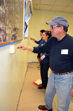 Photo of Secretary Fisher painting at the Garfield Senior Center