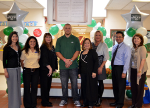 Photo of Oak Street School officials with Jets player Josh Baker