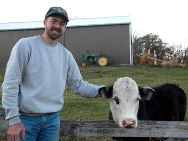 Photo of Mitchell Jones and a cow