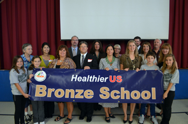 Photo of officials celebrating National Park Elementary School receiving the HUSSCA.