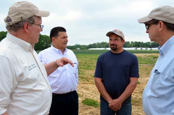 Photo of Peter Furey, Secretary Fisher, Andrew Pagnini and Freeholder Fiocchi in Pagnini's herb field.