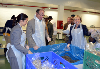 Photo of Commissioner O'Dowd, Secretary Fisher and Acting Governor Guadagno packing rice