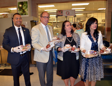 Photo of Secretary Fisher and Diana Limbacher with school superintendent Silvia Abbato and school principal Rudy Baez