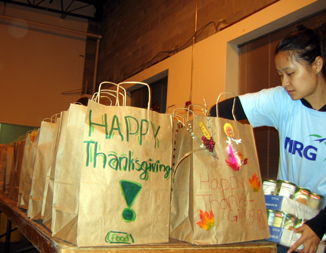 Photo of a volunteer packing grocery bags for the hungry