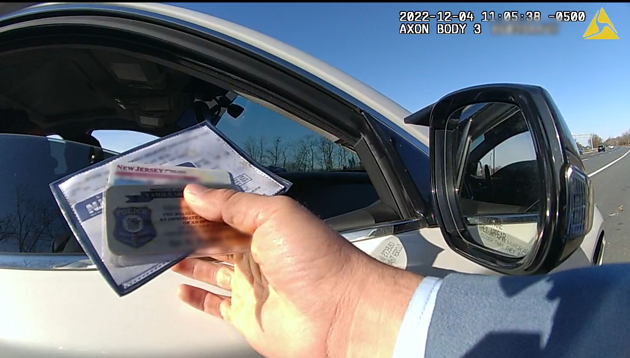 Photo: Officer examines documents during a traffic stop