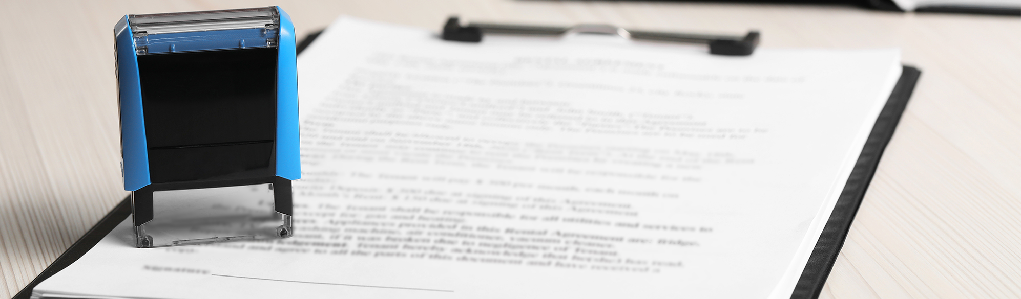 Photo: Contract, clip board, and stamp