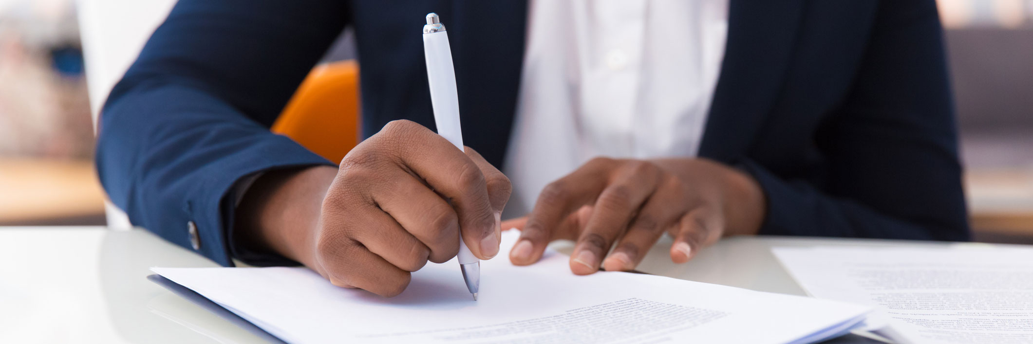  Man in suit writing on the paper