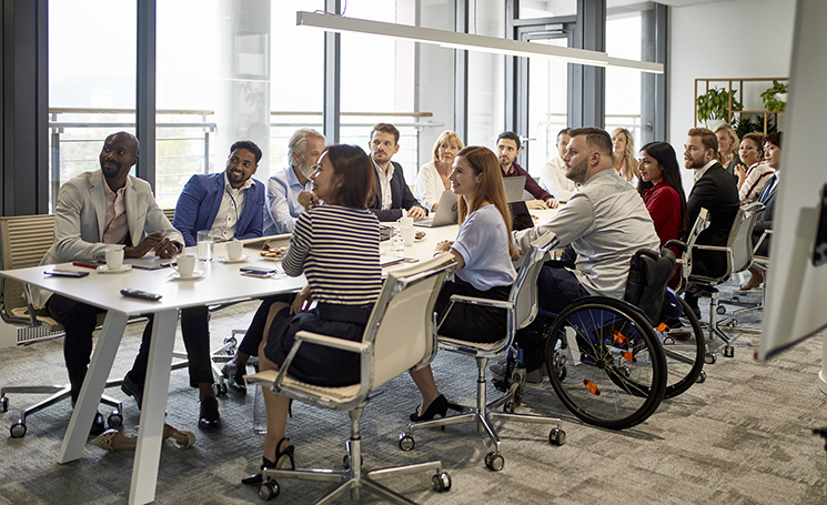 photo: office meeting, professional people by a long table