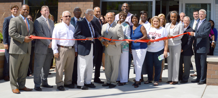 People cutting the ribbon to celebrate the opening of 70 Units of Affordable Rental Housing for Seniors
